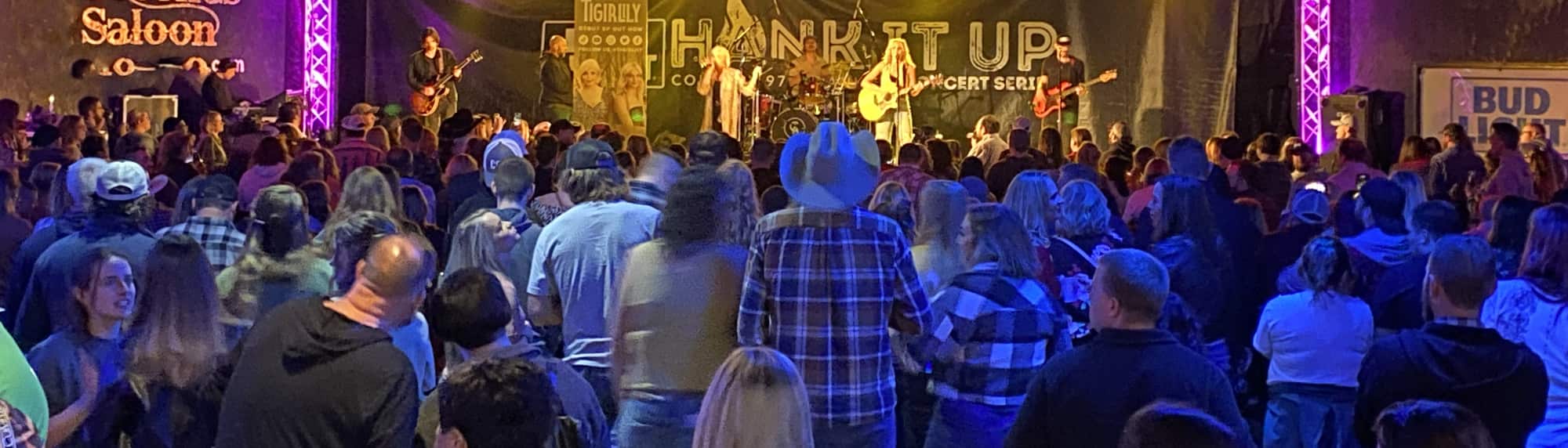 country concert with fans wearing cowboy hats Pensacola